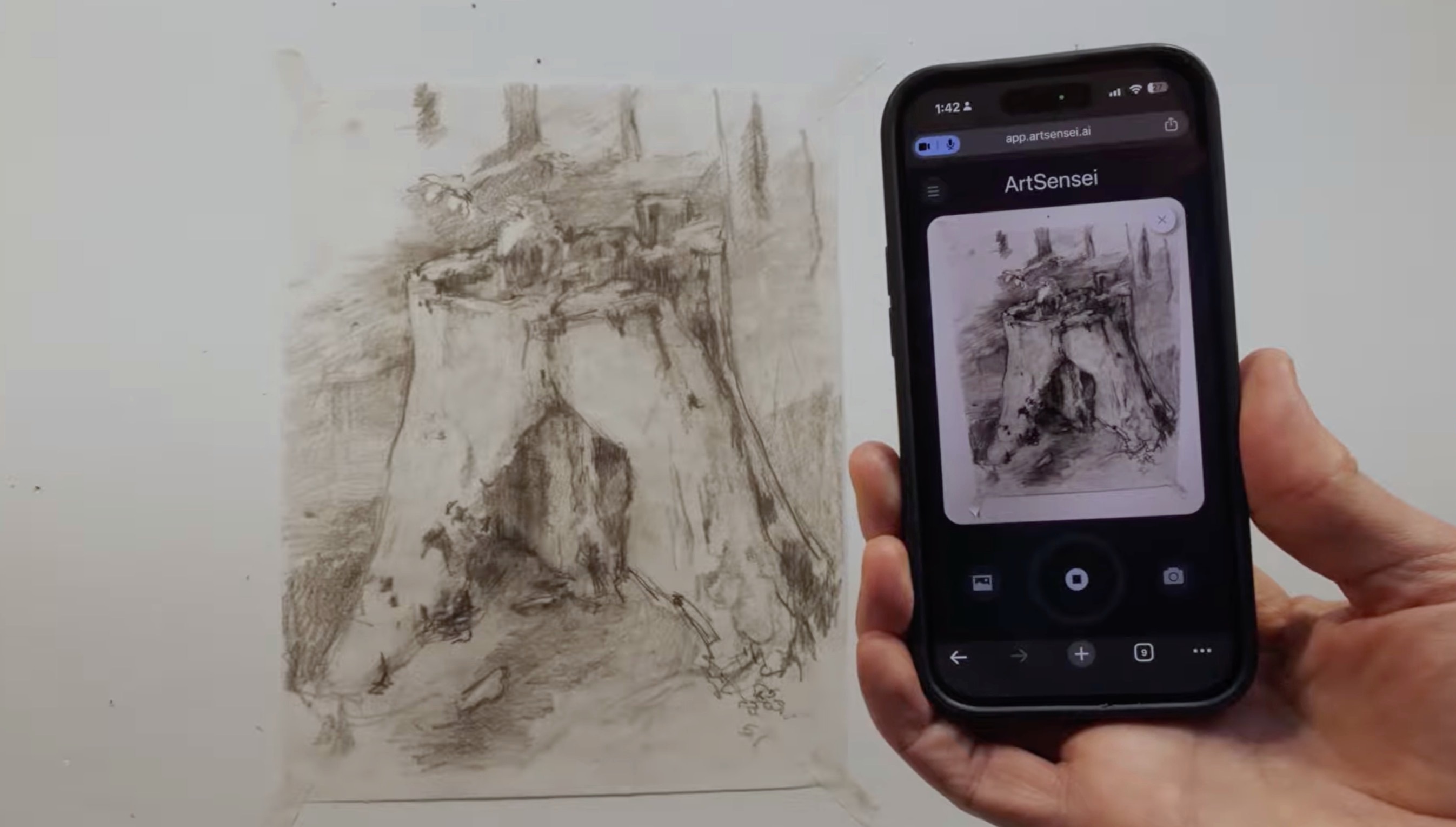 A phone using ArtSensei to view an artist's charcoal drawing